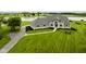 Stunning home boasts manicured lawn and stone accents near a serene lake at 5758 N 900 W, Thorntown, IN 46071