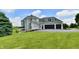 Home exterior featuring a three-car garage and landscaped grounds at 5758 N 900 W, Thorntown, IN 46071