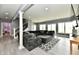 Open living room showcasing a comfortable sofa, neutral decor, staircase, and bright natural light from large windows at 5758 N 900 W, Thorntown, IN 46071