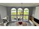 Bright living room features high ceilings, three large windows with lake views, and hardwood floors at 5758 N 900 W, Thorntown, IN 46071