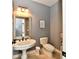 Elegant powder room with marble style pedestal sink, updated fixtures, and neutral wall color at 5758 N 900 W, Thorntown, IN 46071