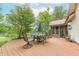 Large back deck with outdoor seating area overlooking the lake and a private backyard at 5821 Bittersweet Rd, Morgantown, IN 46160