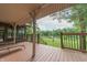 Covered porch with outdoor seating offering serene views of the lake and surrounding greenery at 5821 Bittersweet Rd, Morgantown, IN 46160
