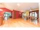 Spacious dining room with wood floors, unique lighting, and adjoining living spaces at 5821 Bittersweet Rd, Morgantown, IN 46160