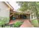 Charming front porch with a brick facade, a cozy seating area, and a welcoming walkway at 5821 Bittersweet Rd, Morgantown, IN 46160