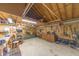 Spacious garage interior with pegboard walls, work bench, tools, storage cabinets, and ample room for projects at 5821 Bittersweet Rd, Morgantown, IN 46160