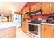 Well-lit kitchen with stainless steel appliances, wooden cabinetry, and light countertops at 5821 Bittersweet Rd, Morgantown, IN 46160