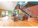 Inviting living area with hardwood floors, a fireplace, and a staircase to an upper level at 5821 Bittersweet Rd, Morgantown, IN 46160
