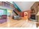 Bright living room with a soaring ceiling, exposed beam, hardwood floors, and cozy fireplace at 5821 Bittersweet Rd, Morgantown, IN 46160