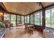 Sunroom with large windows and peaceful views of the backyard and lake at 5821 Bittersweet Rd, Morgantown, IN 46160