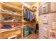 Organized walk-in closet with built-in shelving and a modern hot water tank at 5821 Bittersweet Rd, Morgantown, IN 46160