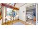 Relaxing screened-in balcony featuring outdoor seating, wood flooring, and an open doorway at 608 Cielo Vista Dr, Greenwood, IN 46143