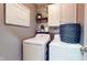 Functional laundry room equipped with a washer, dryer, and overhead storage cabinets at 608 Cielo Vista Dr, Greenwood, IN 46143