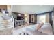 Cozy living room featuring a large couch, decorative mirror, and entertainment center near staircase at 608 Cielo Vista Dr, Greenwood, IN 46143