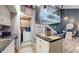 Bright open living space featuring stainless appliances, white cabinets, island, and stairs to the loft at 608 Cielo Vista Dr, Greenwood, IN 46143