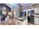 Open-concept space featuring an island, stainless appliances, modern light fixtures and hardwood floors at 608 Cielo Vista Dr, Greenwood, IN 46143