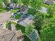 Aerial view of home near a pond, showcasing its well-maintained lawn and proximity to neighboring homes at 7061 Woodgate Cir, Fishers, IN 46038