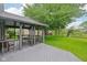 A beautifully screened back porch looks out over a well manicured lawn and pond at 7061 Woodgate Cir, Fishers, IN 46038