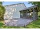 Back of house with a covered porch and adjacent deck, surrounded by lush green lawn at 7061 Woodgate Cir, Fishers, IN 46038