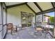 Covered back porch with outdoor seating, sliding glass door to enter the home at 7061 Woodgate Cir, Fishers, IN 46038