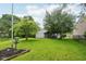 Green backyard featuring a screened porch and lush, well-manicured lawn at 7061 Woodgate Cir, Fishers, IN 46038
