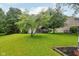 Expansive backyard with healthy grass, mature trees, and a screened-in porch at 7061 Woodgate Cir, Fishers, IN 46038