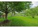 Lush backyard featuring a small pond and an American flag at 7061 Woodgate Cir, Fishers, IN 46038