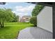 A spacious backyard with a lush lawn and fencing viewed from a grey wood deck at 7061 Woodgate Cir, Fishers, IN 46038