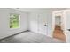 Sunlit bedroom featuring a window and carpet, with a white door and trim at 7061 Woodgate Cir, Fishers, IN 46038