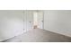 An airy bedroom featuring neutral carpet, white walls, and classic white doors at 7061 Woodgate Cir, Fishers, IN 46038