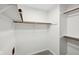Walk-in closet featuring wood clothing racks and white shelving at 7061 Woodgate Cir, Fishers, IN 46038