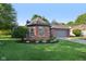 Beautiful brick home with a well-maintained lawn, manicured landscaping, and a gray two-car garage at 7061 Woodgate Cir, Fishers, IN 46038