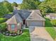 Charming single Gathering home with a two-car garage and a well-manicured front yard in a cul-de-sac at 7061 Woodgate Cir, Fishers, IN 46038