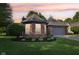 Charming home with brick facade, manicured landscaping, and a two car garage at 7061 Woodgate Cir, Fishers, IN 46038