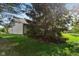 The exterior of this home features mature trees that provide shade, plus a side view of the home at 7061 Woodgate Cir, Fishers, IN 46038