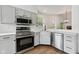 Renovated kitchen featuring stainless appliances, bright countertops, and plenty of natural light at 7061 Woodgate Cir, Fishers, IN 46038