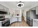 Modern kitchen boasts stainless steel appliances, sleek countertops, and new cabinetry at 7061 Woodgate Cir, Fishers, IN 46038