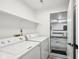 Laundry room with washer and dryer, shelving and access to the garage at 7061 Woodgate Cir, Fishers, IN 46038