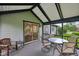 Relaxing screened porch with outdoor seating and a view of the home's exterior at 7061 Woodgate Cir, Fishers, IN 46038