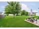 The backyard features a lush green lawn, mature trees and a patio set at 73 Spring Lake Dr, Westfield, IN 46074
