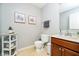 Cozy half-bathroom featuring decorative artwork, a tiled floor, and a classic vanity at 73 Spring Lake Dr, Westfield, IN 46074
