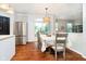 Bright dining room with a large table, stainless steel appliances, and hardwood floors at 73 Spring Lake Dr, Westfield, IN 46074