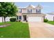 Charming two-story home with brick accents, a well-manicured lawn, and a two-car garage at 73 Spring Lake Dr, Westfield, IN 46074
