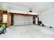 Spacious garage with an automatic door, exposed wooden walls, and ample storage racks at 73 Spring Lake Dr, Westfield, IN 46074