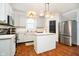 Modern kitchen with white cabinets, stainless steel appliances, and an island at 73 Spring Lake Dr, Westfield, IN 46074