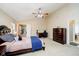 Bright and airy main bedroom featuring a ceiling fan, a dresser, and a desk near a window at 73 Spring Lake Dr, Westfield, IN 46074