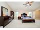 Spacious main bedroom showcasing a dresser with a mirror, a ceiling fan, and a large window at 73 Spring Lake Dr, Westfield, IN 46074