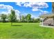 Expansive backyard with a well-maintained lawn and covered patio providing an inviting outdoor space at 7319 Farlin Dr, Whitestown, IN 46075