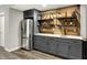 Basement bar area features gray cabinetry, a stainless refrigerator, and wooden accents at 7319 Farlin Dr, Whitestown, IN 46075