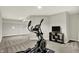 Basement area with an elliptical machine and a television on a stand, ideal for workouts and entertainment at 7319 Farlin Dr, Whitestown, IN 46075